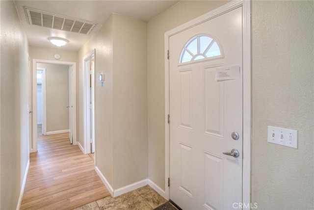 entrance foyer with light wood-style floors, baseboards, and visible vents