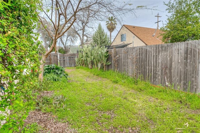 view of yard with a fenced backyard