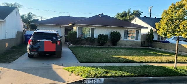 single story home featuring a garage, a front yard, driveway, and fence