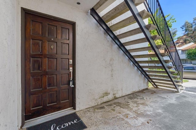 entrance to property with stucco siding