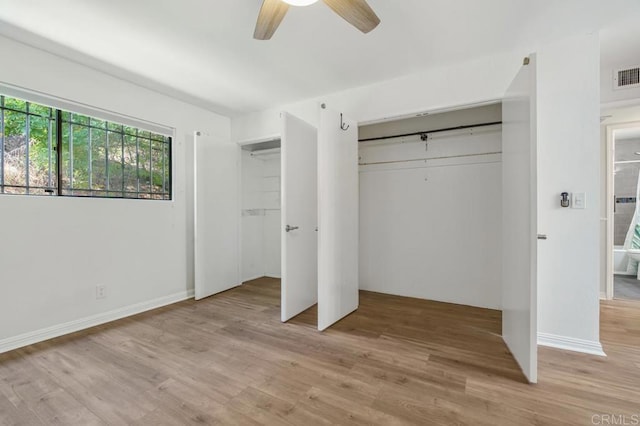 unfurnished bedroom featuring baseboards, light wood finished floors, visible vents, and a ceiling fan