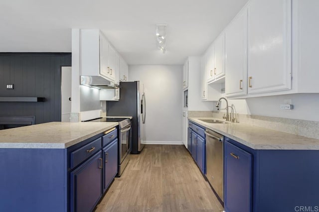 kitchen with appliances with stainless steel finishes, blue cabinets, light countertops, white cabinetry, and a sink