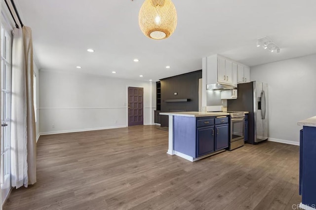 kitchen with under cabinet range hood, appliances with stainless steel finishes, white cabinetry, and light countertops