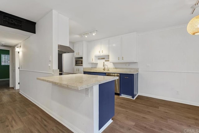 kitchen featuring appliances with stainless steel finishes, blue cabinets, white cabinets, and dark wood-type flooring