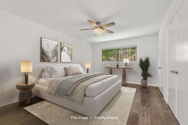 bedroom featuring dark wood-style floors, a ceiling fan, and baseboards