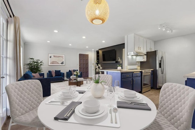 dining space featuring light wood-style floors and recessed lighting