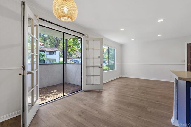 interior space featuring baseboards, wood finished floors, and recessed lighting