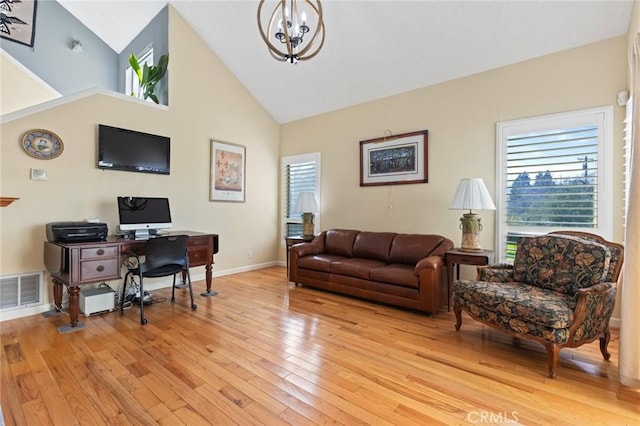 office featuring a notable chandelier, visible vents, light wood-style flooring, high vaulted ceiling, and baseboards