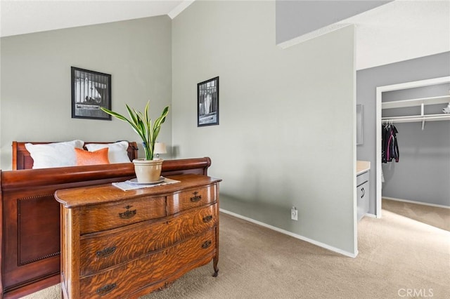 bedroom with light carpet, baseboards, a closet, and lofted ceiling