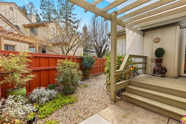 view of yard featuring a fenced backyard, a wooden deck, and a pergola