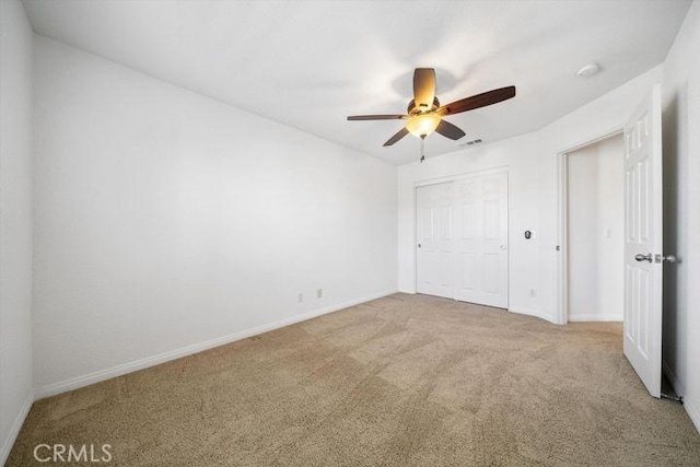 unfurnished bedroom with a closet, carpet, visible vents, and baseboards