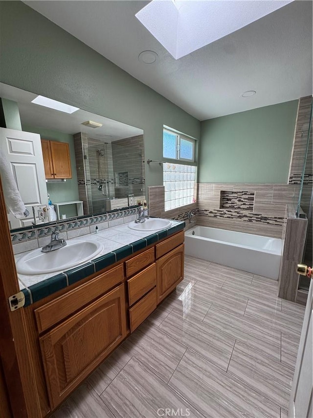 7687 Chase Ave, Hesperia, CA 92345 - full bath featuring a skylight, a shower stall, double vanity, a bath, and a sink