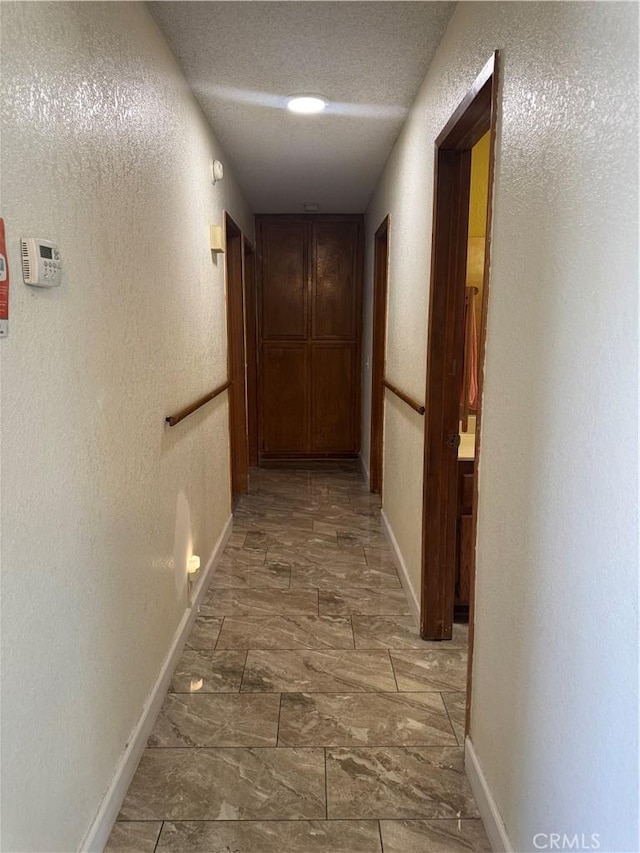 7687 Chase Ave, Hesperia, CA 92345 - corridor featuring baseboards, a textured ceiling, and a textured wall
