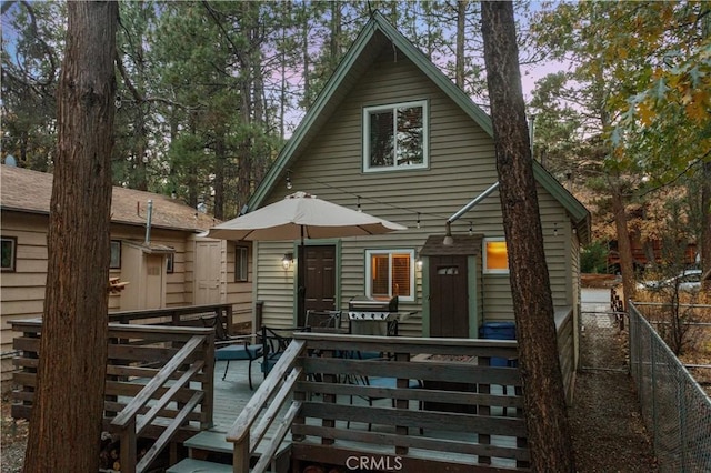 view of front of property featuring a deck and fence