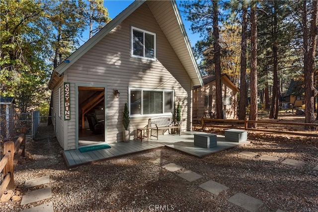 rear view of property featuring fence