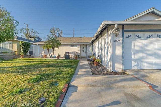 view of home's exterior with a garage, a lawn, and stucco siding