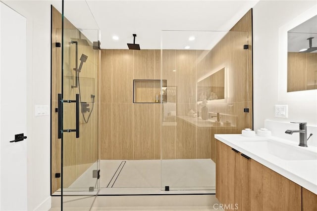 bathroom featuring a stall shower, vanity, and recessed lighting