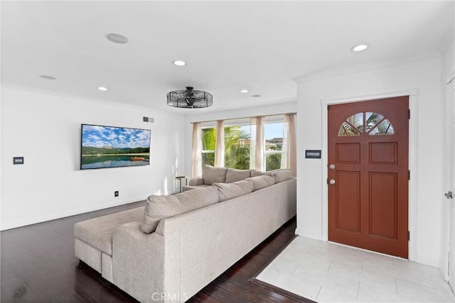 living room featuring ornamental molding, recessed lighting, visible vents, and baseboards