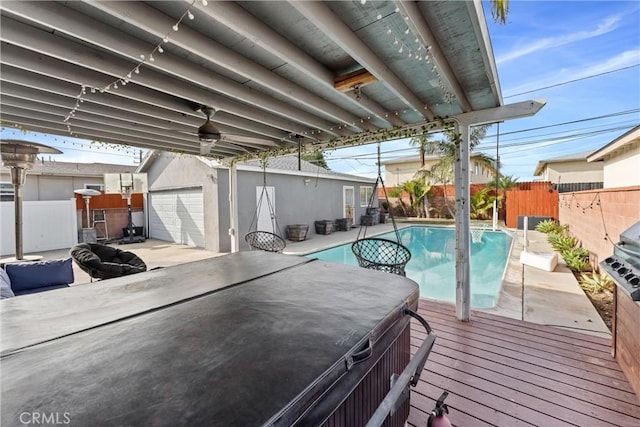 exterior space featuring a fenced in pool, an outbuilding, a fenced backyard, and a hot tub