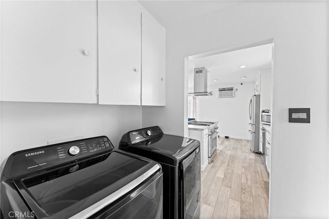 washroom featuring light wood-style floors and washer and dryer