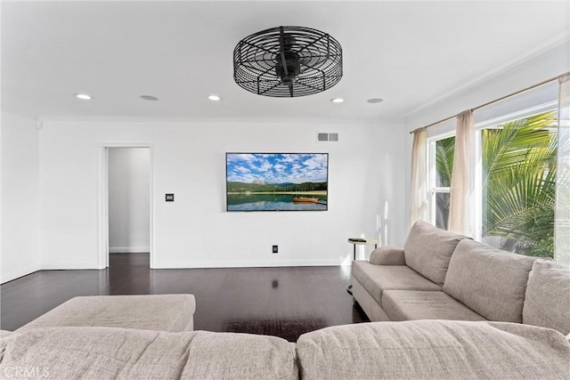 living room with recessed lighting, baseboards, visible vents, and ornamental molding