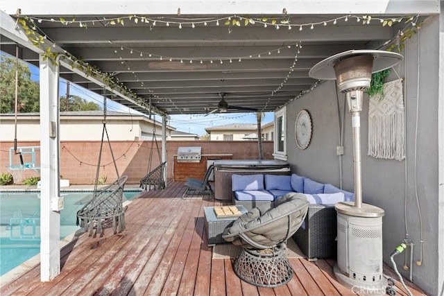 wooden deck with area for grilling, fence private yard, a fenced in pool, and a hot tub