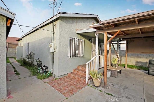 view of property exterior featuring a patio and stucco siding