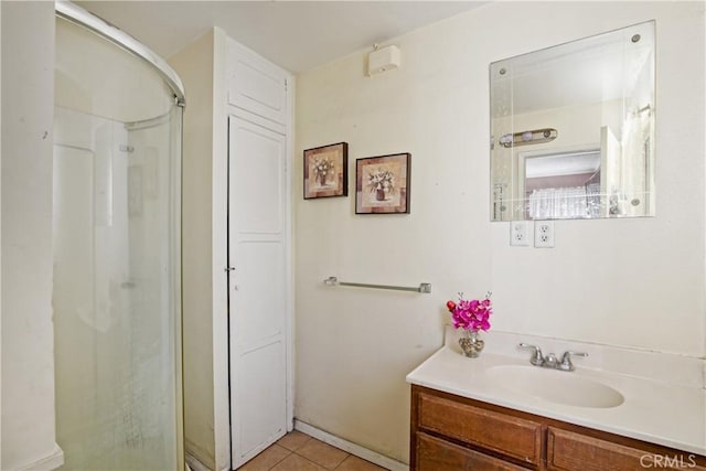 bathroom with vanity, a shower, and tile patterned floors