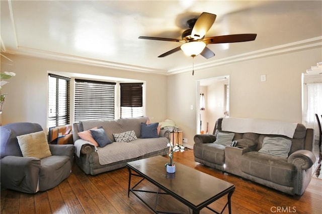 living area with hardwood / wood-style flooring, ceiling fan, baseboards, and crown molding