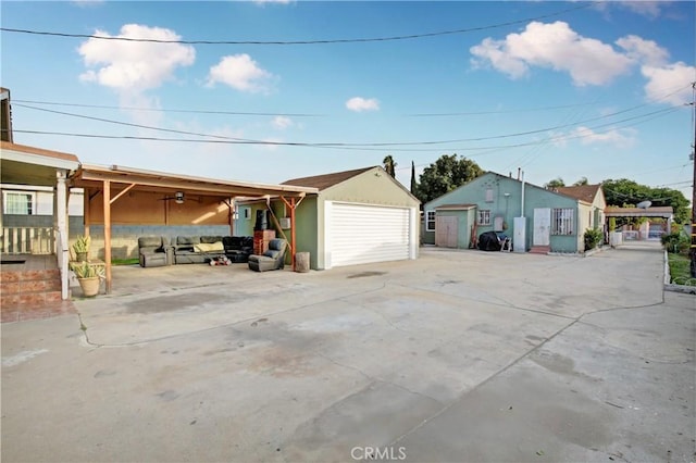 exterior space with a garage, stucco siding, and an outbuilding