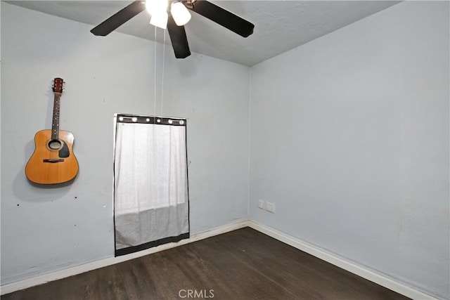 unfurnished room featuring wood finished floors and baseboards