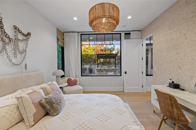 bedroom with light wood finished floors and recessed lighting