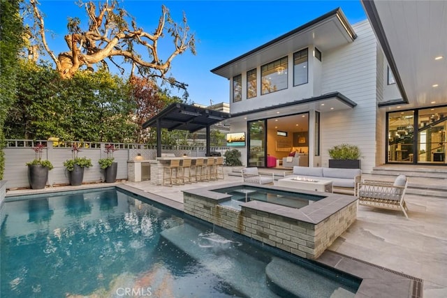 back of property featuring an in ground hot tub, exterior bar, outdoor lounge area, fence, and a fenced in pool