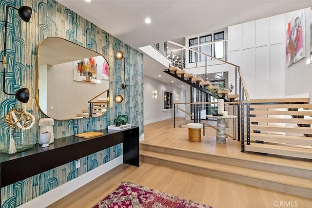 entrance foyer featuring light wood-style flooring, recessed lighting, stairway, and baseboards