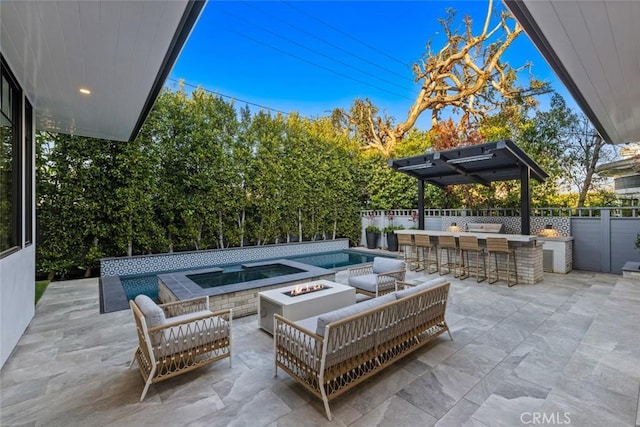 view of patio with outdoor dry bar, an outdoor living space with a fire pit, a fenced in pool, and fence