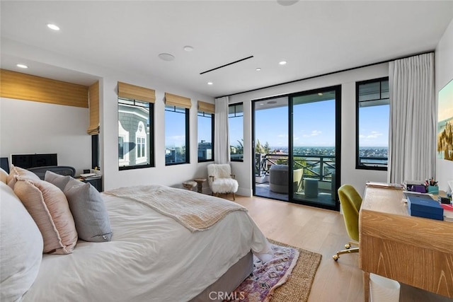 bedroom featuring access to exterior, recessed lighting, and light wood-style floors