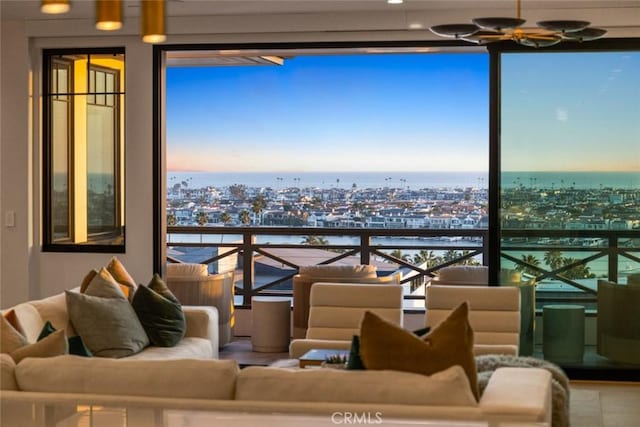 balcony with a water view, outdoor lounge area, and a city view