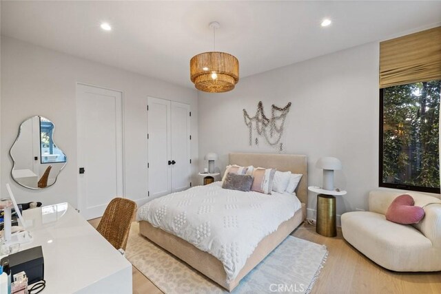 bedroom with light wood-type flooring and recessed lighting