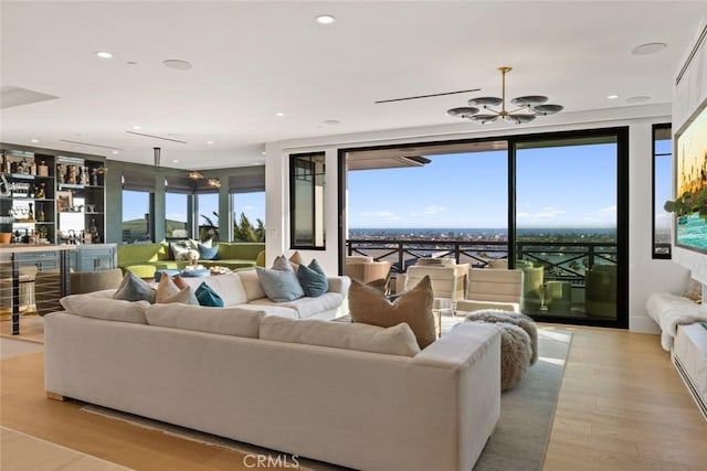 living area with light wood finished floors, a wealth of natural light, and recessed lighting