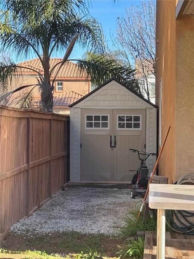 view of shed with fence