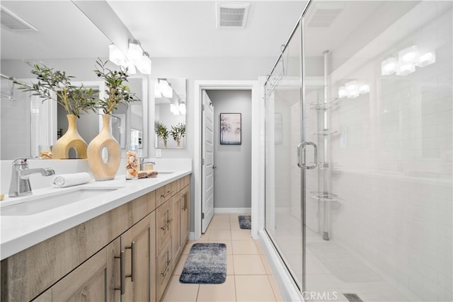 bathroom featuring a stall shower, a sink, visible vents, and tile patterned floors