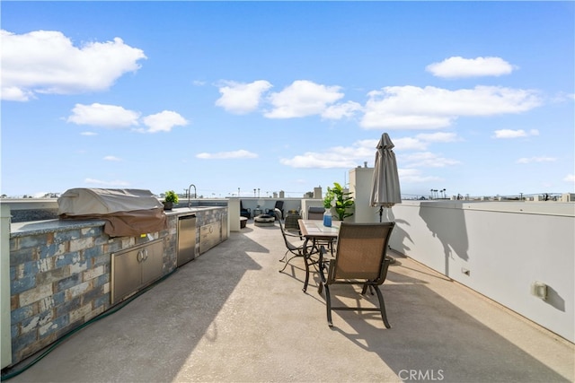 view of patio / terrace with outdoor dining space, an outdoor kitchen, a sink, and area for grilling