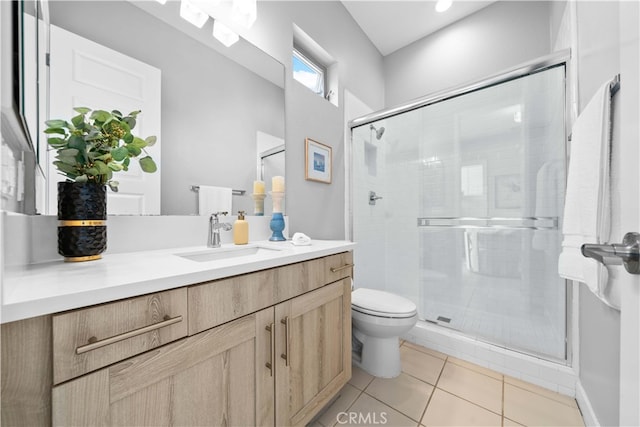 bathroom with toilet, a stall shower, tile patterned flooring, and vanity