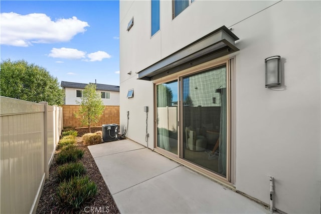 view of patio / terrace with fence and central air condition unit