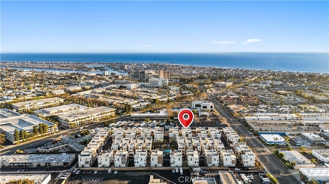 birds eye view of property with a water view and a city view