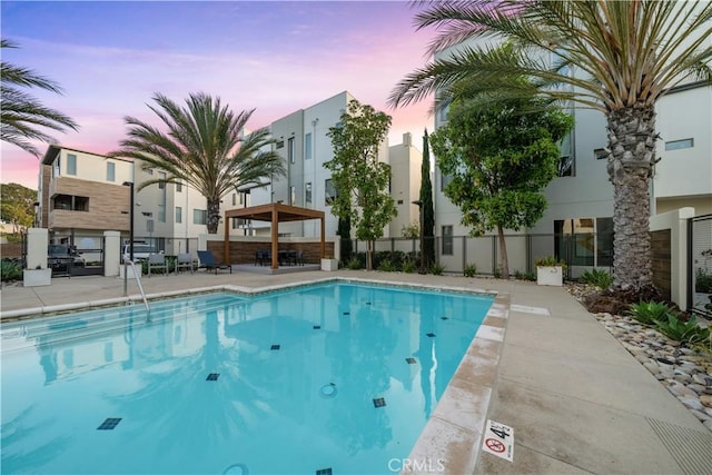 pool featuring fence and a patio