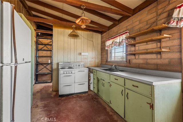 kitchen with vaulted ceiling with beams, a sink, green cabinets, light countertops, and freestanding refrigerator