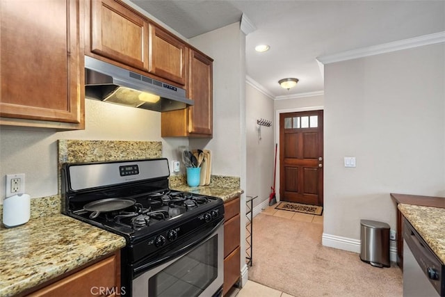 kitchen with light stone counters, crown molding, light colored carpet, appliances with stainless steel finishes, and under cabinet range hood