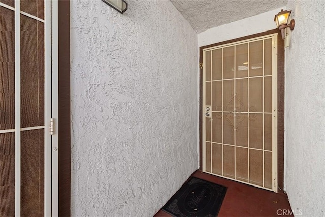 entrance to property featuring stucco siding