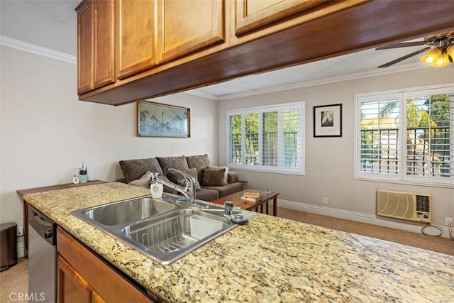 kitchen featuring light stone counters, a sink, open floor plan, stainless steel dishwasher, and ornamental molding